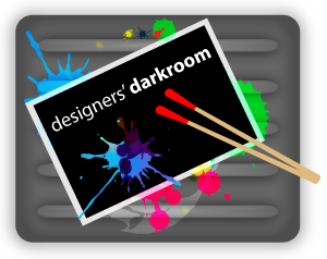 Designers' Darkroom Logo depicts a film fixing tray with a single developed negative with blog name covered in paint.
