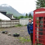 Thomas M Thurston stands outside a red phone booth in Glencoe, Scotland.