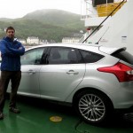 Thomas M Thurston standing next to a silver Ford Focus Diesel on the Mallaig Ferry in Scotland